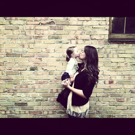 Woman kissing young daughter