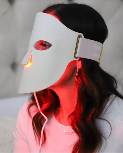 Woman using PMD LED Mask for mobile background image